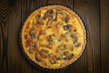 Mushroom pie on a brown wooden table
