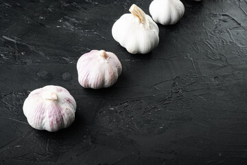 Pile of organic farm garlic, on black background , with copyspace  and space for text