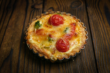 French quiche pie on a brown wooden table
