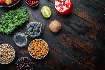 Superfoods dieting concept, top view on dark wooden background, with copy space