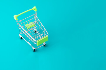 Shopping concept, shopping cart on a blue background with copy space