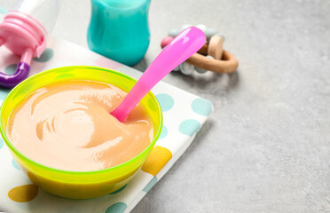 Healthy baby food on grey table. Space for text