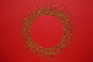 Frame of gold glitter on red background, top view. Space for text