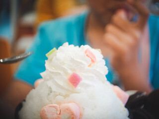 Korean shaved ice dessert with the child eating it