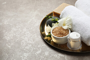 Spa composition with sea salt on grey marble table, space for text