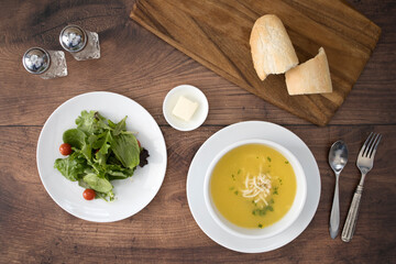 Chicken Noodle Soup and Salad on a Wooden Table