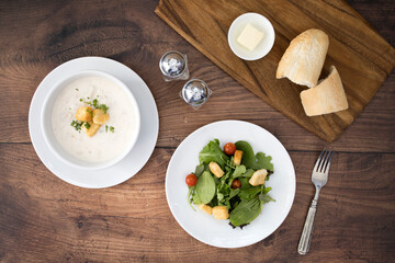 A Bowl of Clam Chowder and a Salad