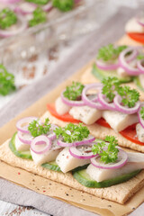 Sandwiches with herring and vegetables