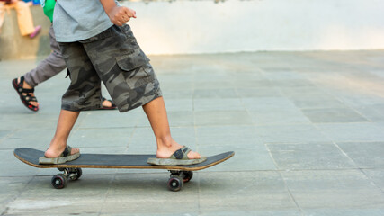 young skateboarder foot in action on a skateboard