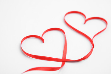 Hearts made of red ribbon on white background. Valentine's day celebration