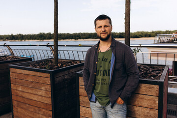 Portrait of a guy outdoors. Summer walk around the city.