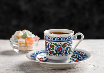 Turkish Coffee with traditional porcelain cup. Coffee presentation with Turkish delight. Sparkling Turkish Coffee.