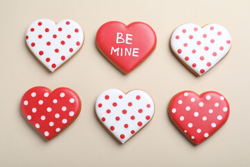 Fototapeta premium Delicious heart shaped cookies on beige background, flat lay. Valentine's Day