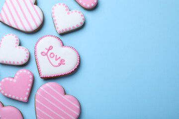 Delicious heart shaped cookies on light blue background, flat lay with space for text. Valentine's Day