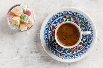 Turkish Coffee with traditional porcelain cup. Coffee presentation with Turkish delight. Sparkling Turkish Coffee.