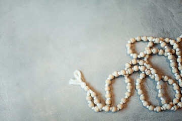 Top view white rosary beads isolated on the grey background