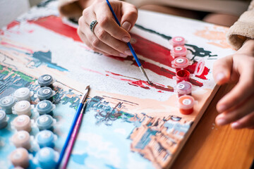 artist draws a picture, painting a picture with a brush, a girl draws a picture, self-isolation, home hobby, creativity at home, bright colors, positive mood, relax retreat