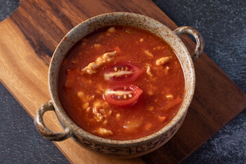 Tomato Soup with Chicken in a Cup on a Black Table