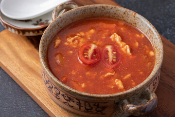 Tomato Soup with Chicken in a Cup on a Black Table