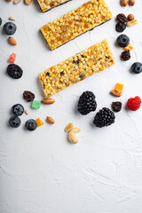 Naklejka na ściany i meble Raw organic granola bars with seeds and nuts, top view with copy space, on white background