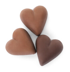 Tasty heart shaped chocolate candies on white background, top view. Valentine's day celebration