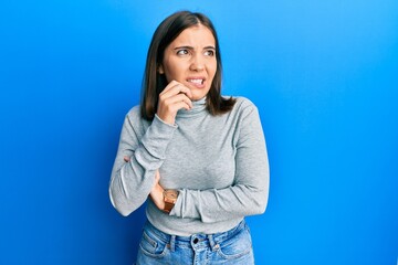 Fototapeta premium Young caucasian woman wearing casual turtleneck sweater with serious expression on face. simple and natural looking at the camera.