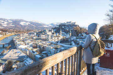 Fototapeta premium Enjoying the view over Salzburg: Young tourist woman on the viewing platform