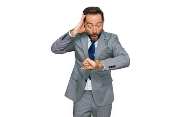 Middle age man wearing business clothes looking at the watch time worried, afraid of getting late