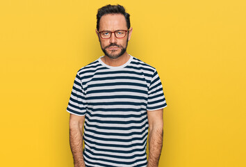 Fototapeta premium Middle age man wearing casual clothes and glasses depressed and worry for distress, crying angry and afraid. sad expression.