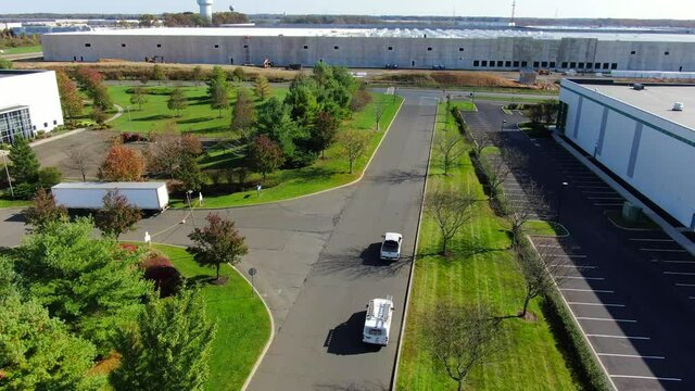 Birds Eye Shot of Business Vans Driving Down a Street