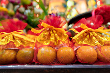 Bag set of orange fruits use for praying respect to Chinese god during Chinese new year ceremony. Religion and culture photo, close-up and selective focus at the orange part.