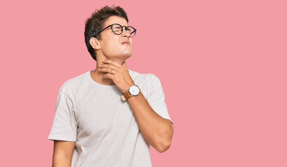 Handsome caucasian man wearing casual clothes and glasses touching painful neck, sore throat for flu, clod and infection