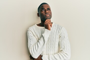 Young african american man wearing casual clothes with hand on chin thinking about question, pensive expression. smiling and thoughtful face. doubt concept.