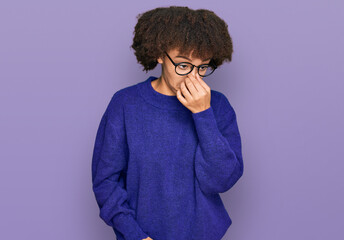 Young hispanic girl wearing casual winter sweater and glasses tired rubbing nose and eyes feeling fatigue and headache. stress and frustration concept.