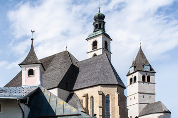 Fototapeta na wymiar An old church with a bell tower in the center of the legendary ski Kitzbuhel