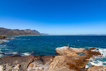 Fototapeta na wymiar Cliff at blue sea at Hermanus south Africa