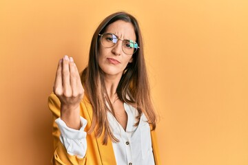 Young beautiful woman wearing business style and glasses doing italian gesture with hand and fingers confident expression