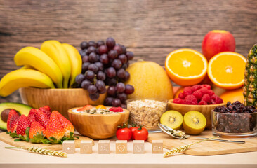 Group Fruits mixed with banana, orange, strawberry and nuts, concept health food and diet, vegetarian food in the top view on the wood table.