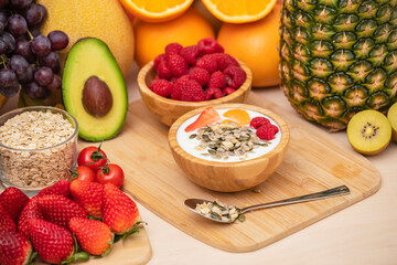Group Fruits mixed with banana, orange, strawberry and nuts, concept health food and diet, vegetarian food in the top view on the wood table.