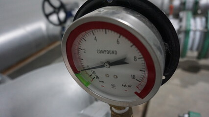 Industrial pressure gauge at the pipe for air compressor installation.