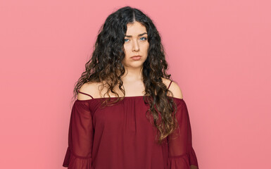 Fototapeta premium Young hispanic girl wearing casual clothes skeptic and nervous, frowning upset because of problem. negative person.