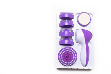 Electric isolate facial massager . Purple massager. Facial care. Cosmetology. Women's care . Article about the health of the face . . Copy space