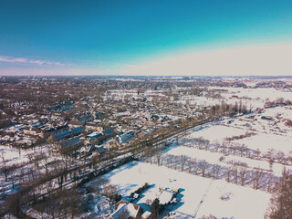 Aerial drone shot of the snowy landscape of the Netherlands.
