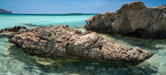 The other side of Elafonisi beach, a stone beach overlooking the blue sea. Crete island, Greece