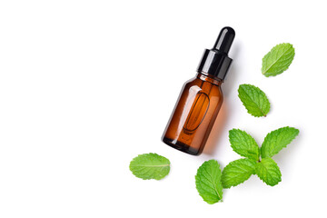 Flat lay (top view) of  Mint essential oil in amber dropper bottle with fresh leaves isolated on white background.