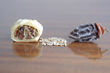 dried fruits and nuts roll. dried persimmon fruit and sunflower seeds baked in a roll. healthy and energy food concept