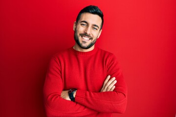 Young hispanic man wearing casual clothes happy face smiling with crossed arms looking at the camera. positive person.