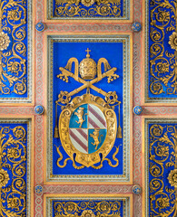 Fototapeta na wymiar Pope Pius IX emblem on the coiling of the Basilica of San Nicola in Carcere in Rome, Italy. 