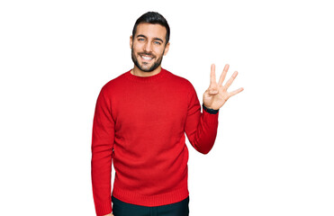 Young hispanic man wearing casual clothes showing and pointing up with fingers number four while smiling confident and happy.