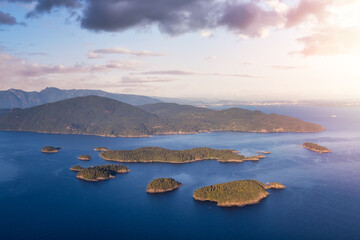 Fototapeta premium Aerial view of Pasley Island and Howe Sound during a vibrant sunny summer day. Sunset Sky Art Render. Located in Sunshine Coast, Northwest of Vancouver, BC, Canada.